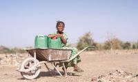 Young Girl Collecting fresh water. 123rf