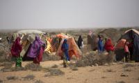 Women walk in a camp for internally displaced people in Uusgure village, Puntland, Somalia. Due to the current drought, they have lost almost all their livestock, camels and goats, on which they depend to survive. © FAO/Karel Prinsloo
