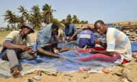 Fishermen repairing their nets.
