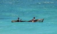 Two young people sailing in a traditional boat. Photo: Giuseppe Caramazza