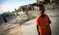 A group of children on the streets behind Lido Beach in the Kaaraan District. UN Photo/Stuart Price